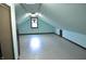 Spacious unfinished attic space with a window and neutral paint offers potential for customization at 931 Beech Dr, Greenwood, IN 46142
