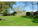 Lush green backyard with ample space for recreation, featuring a wooden fence for privacy at 931 Beech Dr, Greenwood, IN 46142