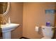 Small bathroom with white toilet and sink and tan walls at 931 Beech Dr, Greenwood, IN 46142