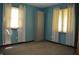 Bedroom with blue walls, carpet, and windows on two walls at 931 Beech Dr, Greenwood, IN 46142