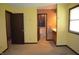 Bedroom with yellow walls and doors to the bathroom at 931 Beech Dr, Greenwood, IN 46142