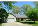 Traditional home featuring an attached garage, walkway, and manicured landscaping at 931 Beech Dr, Greenwood, IN 46142