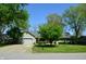 Charming single-story home featuring an attached garage, inviting curb appeal, and mature trees at 931 Beech Dr, Greenwood, IN 46142