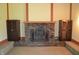 Cozy brick fireplace flanked by wooden cabinets adds warmth and character to the living space at 931 Beech Dr, Greenwood, IN 46142