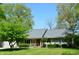 Charming single-story home with well-manicured lawn and mature trees at 931 Beech Dr, Greenwood, IN 46142
