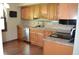 A charming kitchen featuring wood cabinets, granite countertops, and hardwood floors at 931 Beech Dr, Greenwood, IN 46142
