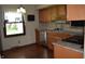 A charming kitchen featuring wood cabinets, a granite countertop, and hardwood floors at 931 Beech Dr, Greenwood, IN 46142
