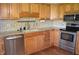 A kitchen with wood cabinets, granite countertops, stainless steel appliances, and hardwood floors at 931 Beech Dr, Greenwood, IN 46142