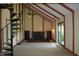 Inviting living room featuring a brick fireplace, vaulted ceilings, and a unique spiral staircase at 931 Beech Dr, Greenwood, IN 46142