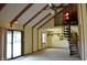 Bright living room boasting vaulted ceilings, a spiral staircase, and sliding glass doors to the outdoors at 931 Beech Dr, Greenwood, IN 46142