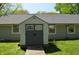 Charming backyard shed with double doors and windows offers extra storage and complements the home's exterior at 931 Beech Dr, Greenwood, IN 46142