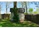 Backyard shed with a wooden door and mature trees, providing a functional and private storage space at 931 Beech Dr, Greenwood, IN 46142