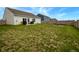 Sprawling backyard with lawn and a patio, enclosed by a wooden fence at 932 Sagittarius Ave, Franklin, IN 46131