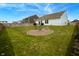 Fenced backyard featuring green lawn space and a circular fire pit with chairs at 932 Sagittarius Ave, Franklin, IN 46131