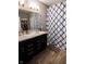 Bathroom with double sink vanity with marble countertops and patterned shower curtain at 932 Sagittarius Ave, Franklin, IN 46131