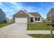 Charming home features a two-car garage, well-manicured lawn, and tasteful landscaping at 932 Sagittarius Ave, Franklin, IN 46131