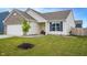 Well-maintained front yard of a home with a young tree and manicured landscaping at 932 Sagittarius Ave, Franklin, IN 46131