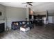 Spacious living room flows into the kitchen, featuring a fireplace and hardwood floors at 932 Sagittarius Ave, Franklin, IN 46131