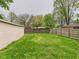 A spacious backyard featuring lush greenery, bounded by a wooden fence that ensures privacy and security at 979 Monroe St, Indianapolis, IN 46229