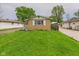 Charming brick home featuring a well-maintained lawn, bright white shutters, and nearby garage at 979 Monroe St, Indianapolis, IN 46229
