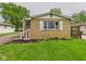 Quaint home with tidy landscaping and attractive yellow brick at 979 Monroe St, Indianapolis, IN 46229