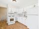 Bright kitchen with white cabinetry, laminate counters, and modern fixtures at 979 Monroe St, Indianapolis, IN 46229