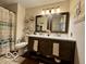 Stylish bathroom featuring a double vanity, decorative mirrors, and shower with curtain at 1018 Redwood Dr, Lebanon, IN 46052