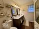 Bright bathroom with a double vanity, decorative mirrors, shelving and natural light at 1018 Redwood Dr, Lebanon, IN 46052