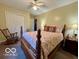 Bright bedroom featuring a full-size bed, rocking chair, dresser, and natural light at 1018 Redwood Dr, Lebanon, IN 46052