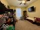Untidy spare bedroom with shelving, window, TV, and full-size bed at 1018 Redwood Dr, Lebanon, IN 46052