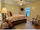 Cozy bedroom with a full bed, rocking chair, window view, and bedside table at 1018 Redwood Dr, Lebanon, IN 46052