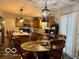 Cozy dining area with a round table, wooden chairs, and an open view into the kitchen at 1018 Redwood Dr, Lebanon, IN 46052