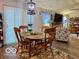 Cozy dining area with a wooden table set on a patterned rug, bathed in natural light at 1018 Redwood Dr, Lebanon, IN 46052
