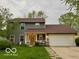 Charming two-story home with a well-manicured lawn and attached two-car garage at 1018 Redwood Dr, Lebanon, IN 46052