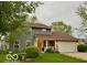 Charming two-story home with green siding, a well-manicured lawn, and an attached two-car garage at 1018 Redwood Dr, Lebanon, IN 46052