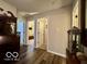 Hallway with hardwood floors, neutral walls, and doors leading to other rooms at 1018 Redwood Dr, Lebanon, IN 46052