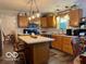 Charming kitchen featuring wood cabinetry, a center island, and a pendant light fixture at 1018 Redwood Dr, Lebanon, IN 46052