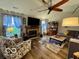Inviting living room with a ceiling fan, fireplace, and comfortable seating at 1018 Redwood Dr, Lebanon, IN 46052