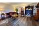 Comfortable living room featuring hardwood floors, vintage furniture, and a decorative fireplace at 1018 Redwood Dr, Lebanon, IN 46052