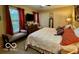 Comfortable main bedroom with large windows, a quilted bed, and ample closet space at 1018 Redwood Dr, Lebanon, IN 46052
