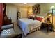 Comfortable bedroom with a king bed, bedside tables, and large closet doors at 1018 Redwood Dr, Lebanon, IN 46052