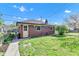 Back view of the brick detached garage featuring a well kept lawn and landscaping at 1029 E Yoke St, Indianapolis, IN 46203
