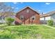 Backyard features a lush green lawn, brick exterior, and natural light, perfect for relaxation and outdoor activities at 1029 E Yoke St, Indianapolis, IN 46203