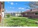 Spacious backyard with green grass and a charming brick home exterior creating an inviting and relaxing outdoor space at 1029 E Yoke St, Indianapolis, IN 46203