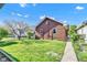 Backyard with lush green grass, mature trees, and a charming brick home, perfect for relaxation and outdoor enjoyment at 1029 E Yoke St, Indianapolis, IN 46203