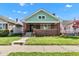 Charming brick home with a front porch and well-maintained lawn on a sunny day at 1029 E Yoke St, Indianapolis, IN 46203
