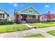 Inviting brick home with a cozy front porch and lush green lawn at 1029 E Yoke St, Indianapolis, IN 46203