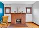 Cozy brick fireplace with wood mantle and leaded glass windows at 1029 E Yoke St, Indianapolis, IN 46203