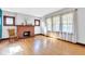 Bright living room featuring hardwood floors, a brick fireplace, and leaded glass windows at 1029 E Yoke St, Indianapolis, IN 46203