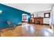 Bright living room featuring hardwood floors, fireplace, and a connected dining area at 1029 E Yoke St, Indianapolis, IN 46203
